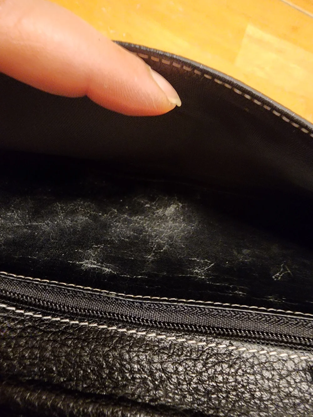 black Christian Dior pebbled leather trifold long wallet featuring gold-tone 